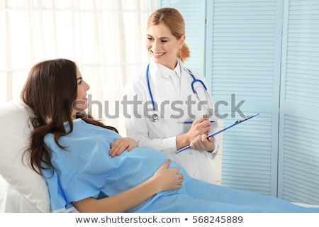 Foto stock: Doctor Fills Out Medical Record
