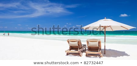 Foto stock: Two Chairs And Umbrella On Stunning Beach