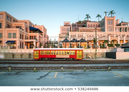 Foto stock: Red Trolley Streetcar On Rail In New Orleans French Quarter