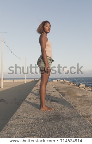 African American Woman Standup In Shorts On Beach Stockfoto © 2Design