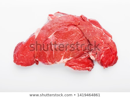 Foto d'archivio: Fresh Raw Organic Slice Of Braising Steak Fillet On Chopping Board With Meat Hatchets On Wooden Back