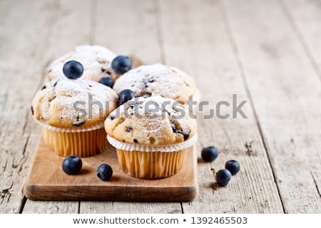 Stok fotoğraf: Four Homemade Fresh Muffins With Blueberries On Rustic Wooden Ta