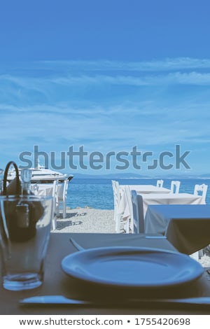 Stok fotoğraf: Empty Restaurant By The Aegean Sea And Cruise Boat Travel And Nature