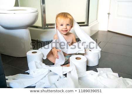 Stock photo: Toddler Ripping Up Toilet Paper In Bathroom