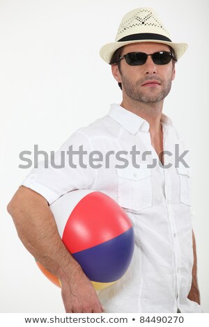 Foto stock: Dude In A Straw Hat On A Sunny Beach