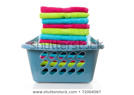 Stockfoto: Laundry Basket Filled With Colorful Folded Towels