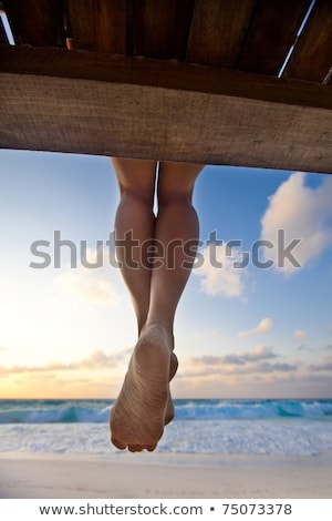 Stock photo: Relaxed Woman With Sandy Legs Sitting On Beach