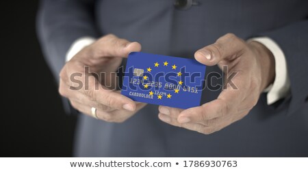 Stockfoto: European Businessman Holding Business Card With Eu Flag