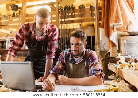 Stockfoto: Carpenters With Blueprint Working At Workshop