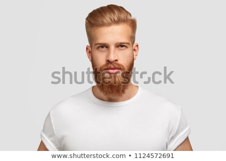 Stock photo: Portrait Of Unshaven Young Man Posing And Looking At Camera