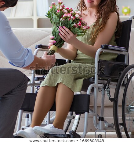 [[stock_photo]]: Man Making Marriage Proposal To Disabled Woman On Wheelchair