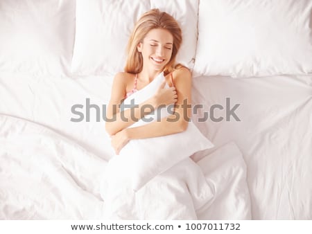 Stock photo: Young Woman Sleeping On The Bed And Hugging Pillow