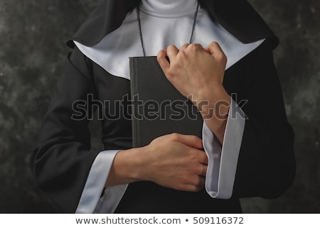 Stockfoto: The Religious Nun In Religion Concept Against Dark Background