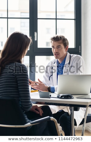 Young Devoted Doctor Listening With Attention To His Patient Foto stock © Kzenon