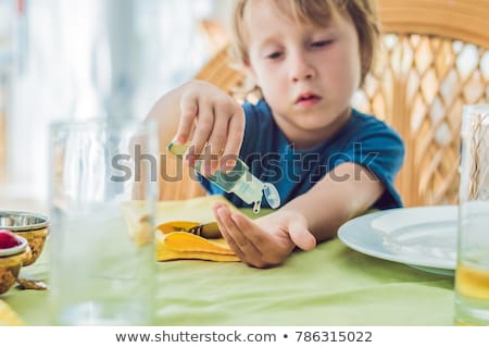 Stock photo: Boy Using Wash Hand Sanitizer Gel In The Cafe