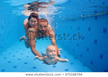 Zdjęcia stock: Family Fitness - Mother Father Baby Son Learn To Swim Together Dive Underwater With Fun In Pool A