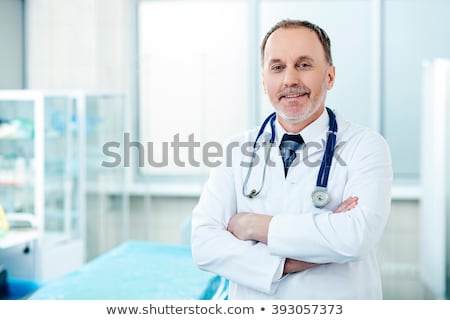 Foto stock: Old Male Doctor Working In The Clinic