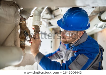 Foto stock: Male Worker Inspecting Valve
