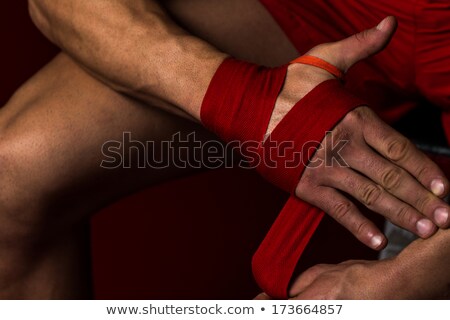 Foto stock: Kick Boxer Putting Straps On His Hands