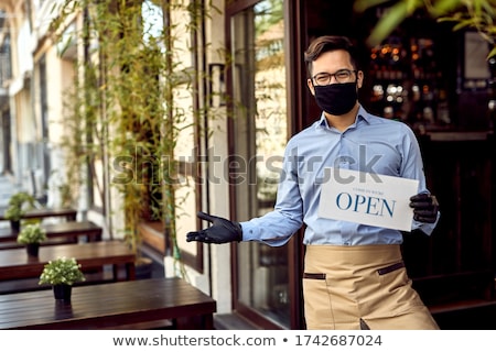 ストックフォト: Business Owner Holding The Sign For The Reopening