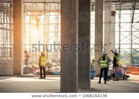 Foto d'archivio: Crane Safety Helmet Blueprints And Construction Site