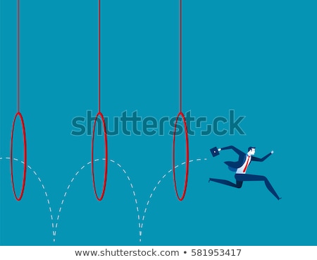 Foto stock: A Man Jumping Through A Hoop