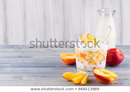 Foto stock: Summer Breakfast With Corn Flakes Slice Peach And Milk Bottle On White Wood Board