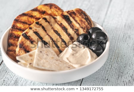 Stock photo: Grilled Chicken Breast With Black Olives And Tahini Sauce