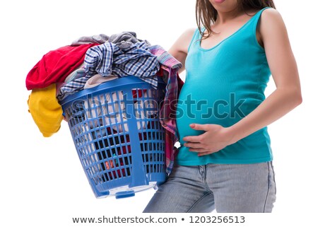 [[stock_photo]]: Woman Holding Basket Of Dirty Clothing Requiring Washing