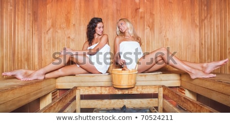 Stok fotoğraf: Two Pretty Young Women Relaxing In The Sauna