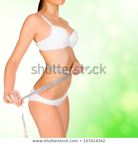 Stock fotó: Girl Taking Measurements Of Her Body Green Blurred Background