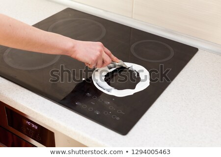 Сток-фото: Woman Cleaning Induction Stove