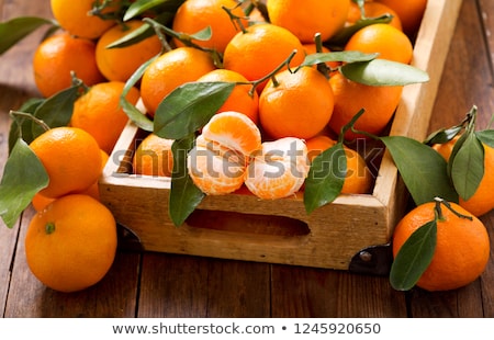 Stockfoto: Fresh Tangerines In Box With Leaves