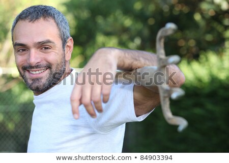 Foto stock: Gardener Carrying A Rake Across His Shoulders