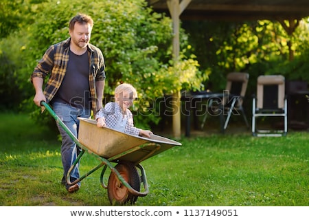 Stock fotó: Family Having Ride In Wheelbarrow In Countryside