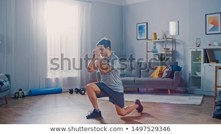 Stock fotó: Athletic Young Man Doing Exercises