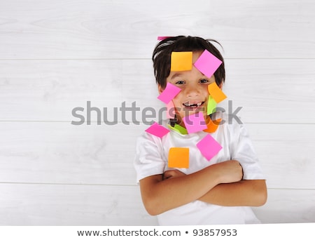 Foto d'archivio: Little Boy With Memo Posts On His Face