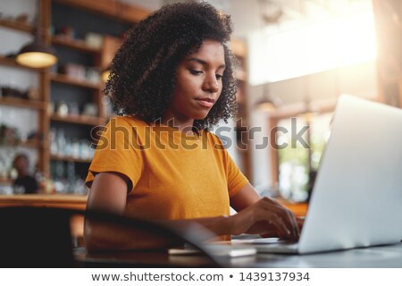 Stockfoto: Front View Of African American Beautiful Woman Using Laptop On Desk At Home During A Breakfast