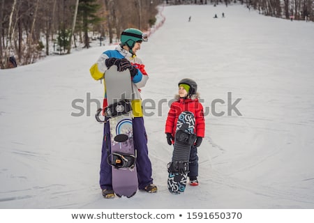 Foto stock: Snowboard Instructor Teaches A Boy To Snowboarding Activities For Children In Winter Childrens Wi