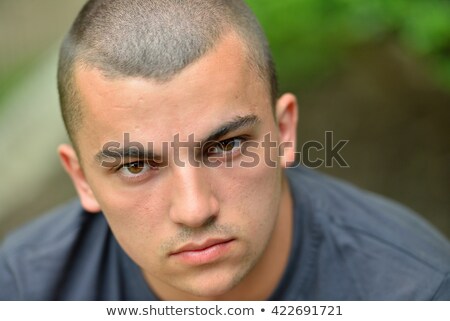 Stockfoto: Headshot Of A Young Man Looking At Camera In Park