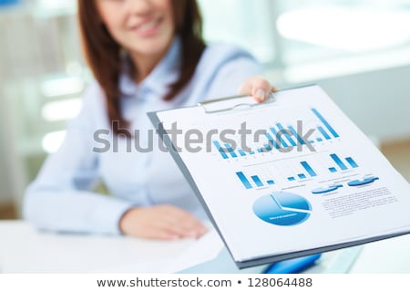Foto d'archivio: Woman And Chart On Clipboard