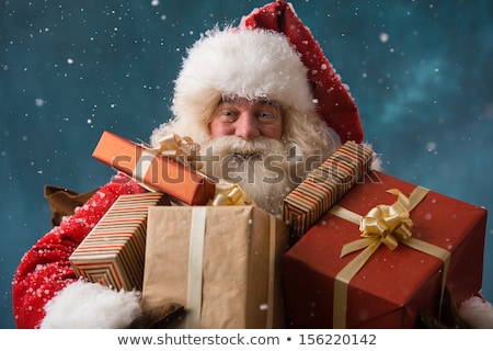 Stockfoto: Santa Claus Carrying Gifts To Children