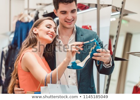 Woman With Her Man Looking At Blue Shoes In Store Foto d'archivio © Kzenon