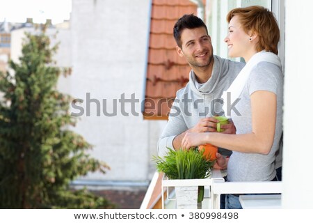 Foto d'archivio: Young Man Having A Coffee In The Balcony