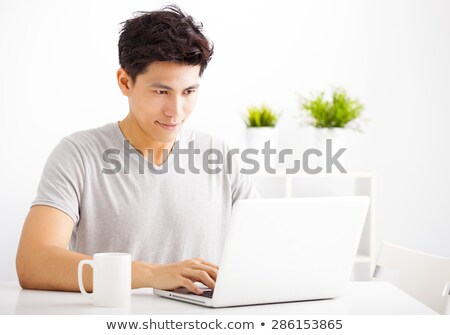 Сток-фото: Handsome Asian Man Using Laptop At Home