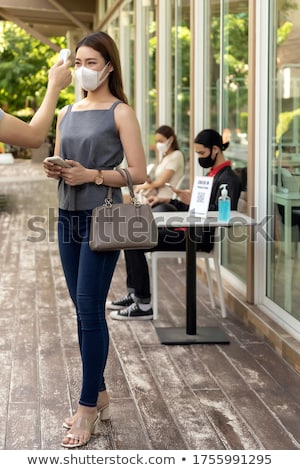 Stockfoto: New Normal Waitress Take Temperature Customer