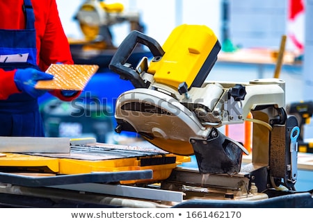 Сток-фото: Man Cutting Tile To Right Size