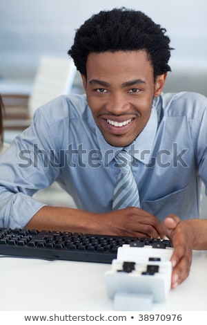 Stockfoto: Attractive Businessman Consulting A Business Card Holder