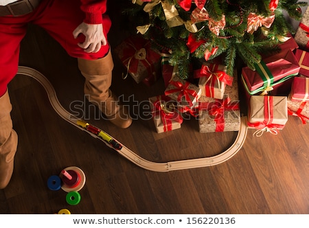 Сток-фото: Unrecognizable Santa Claus Playing With Wooden Railroad Near Chr