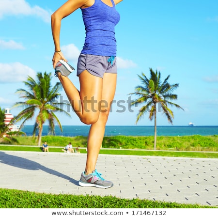 Foto stock: Young Woman Stretching During Sport Training Outdoor